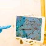 dermatologist-pointing-the-screen-of-a-tablet-duri-2024-12-10-00-36-16-utc dermatologist-pointing-the-screen-of-a-tablet-duri-2024-12-10-00-36-16-utc